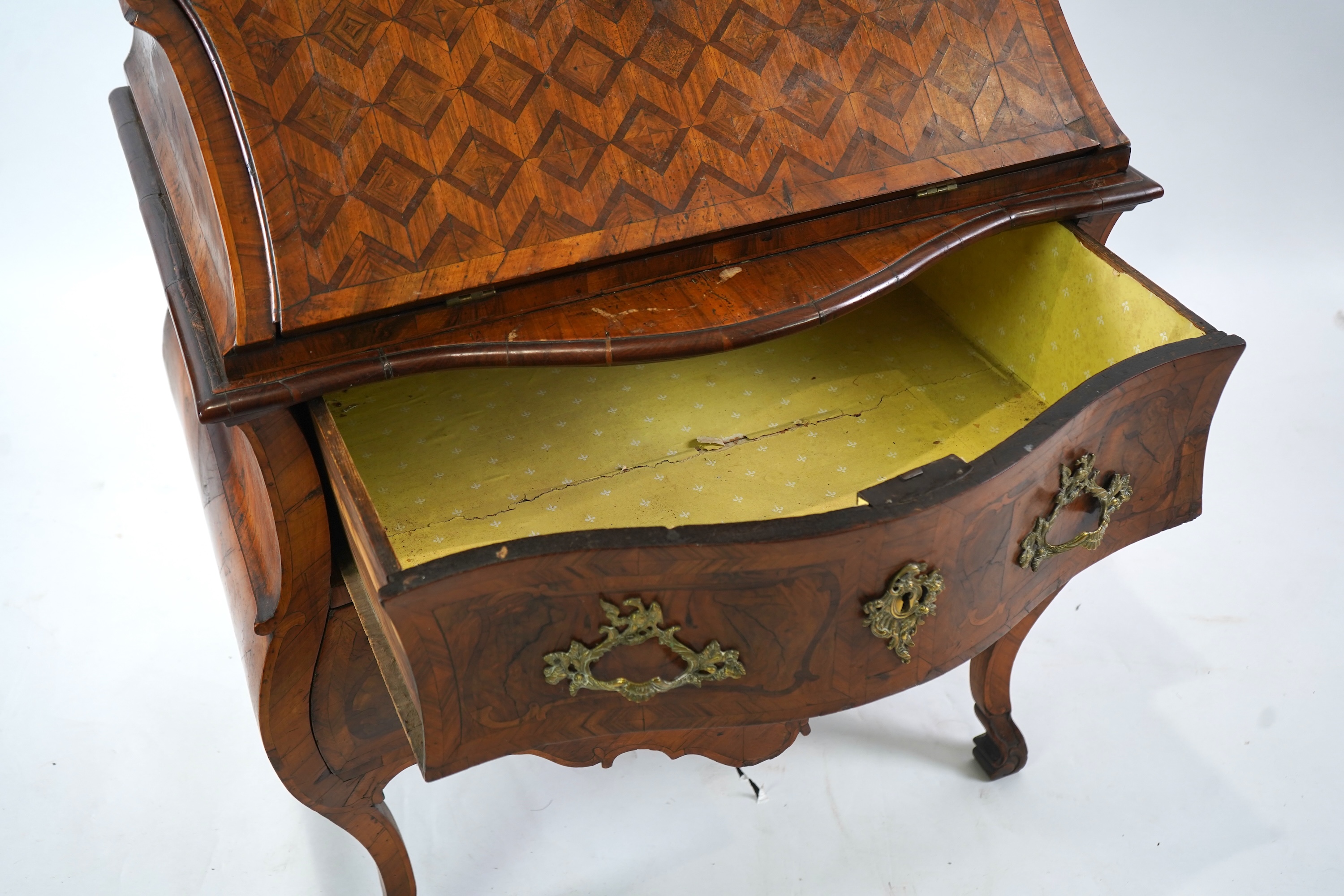 A mid 18th century North Italian or Maltese walnut and olive wood gilt metal mounted serpentine bureau cabinet